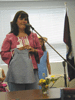 JPEG 80KB - A seminary wife shows the blouse and dress she made during the class.  The girl behind her made the dress she is wearing.