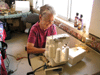 JPEG 113KB - Kathryn Tennison sewing clothes for one of the home's children.