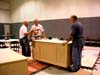 Bob Baugh, Ed Kirkham, and Jim Strong discussing the next step in completing  a desk.