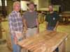 Eugene Esters and the two camp leaders, Eric Small and Will Fisher, talk over a mahogany table we were putting together.