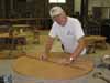 Melvin Williamson, the Furniture Builder Coordinator, is working on the first of 10 round tables we made.