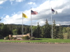 The United States, New Mexico and Christian flags proudly wave at the front gate