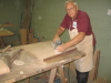 Jack Tennison is sanding a conference table support