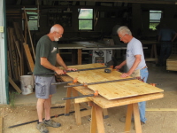 Smitty Qualls and Eugene Esters are making a big board out of small boards (drop offs) to save the camp some money.