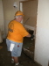 Jerry Bishop is removing the sheetrock below the high water mark from the flood.