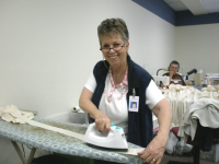 Carolyn Adcock presses bindings for a quilt.